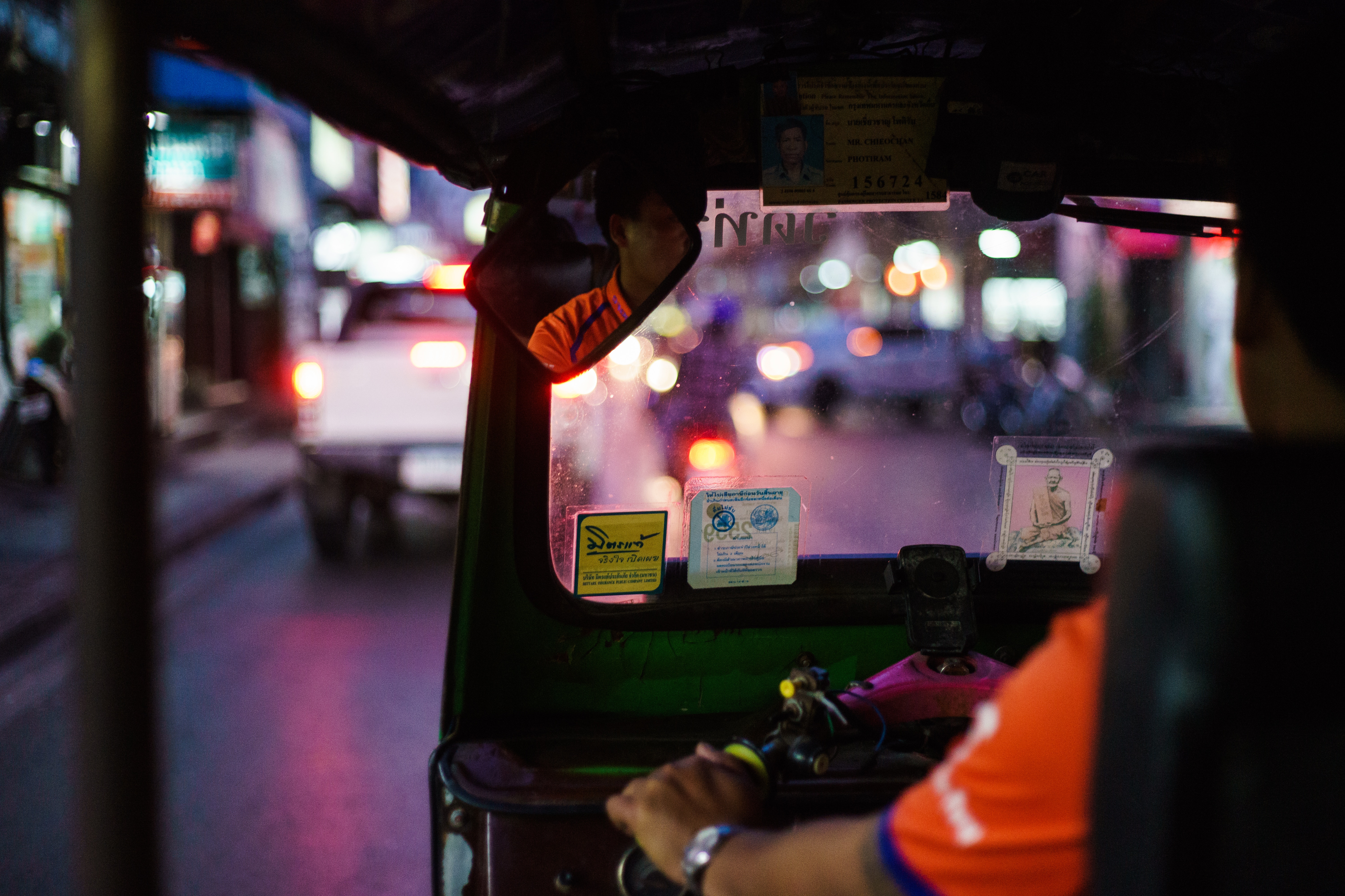 一台tuktuk車朝向不知明的街道駛去。